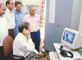 Vice-Chancellor K.N. Pathak talks to Prof Nigavekar via satellite at the launch of EDUSAT system at Panjab University on Saturday. 
