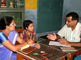 Mr Hans Raj Dhall, Director, Arpan School, Rohtak, and an expert in education of challenged children, counsels a girl and her mother at a camp organised in Hisar