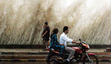 Waves strike the Worli sea front in Mumbai on Sunday during the high tide