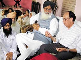 Former Punjab Chief Minister Parkash Singh Badal speaks with Mr S.N. Vinayak whose son, Major Kapil Vinayak, was killed during counter- insurgency operation in Kashmir last week, at his residence in Jalandhar