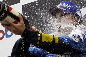 Renaults Formula One driver Fernando Alonso of Spain enjoys champagne after winning the German Formula One Grand Prix at the Hockenheim race track