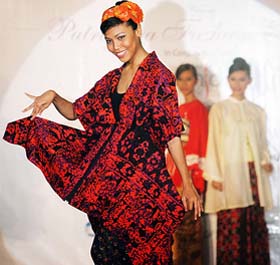 A model displays a batik creation by Malaysian designer Najib Nor during the Kuala Lumpur Fashion Week, 2005, in Putrajaya