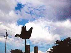 The citys Open Hand monument gives a hearty welcome to the dark clouds that gather on the sky promising a good shower.