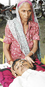 Ms Leela Wati along with her son Charan Singh, who was allegedly attacked by a brick-klin owner and a labour contractor, in front of the Old OPD block of the PGI, Chandigarh, on Monday.