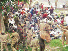 Police lathi-charge agitating workers near Mini Secretariat in Gurgaon on Monday.