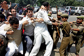 The police struggles with activists of moderate faction of the All-Party Hurriyat Conference during a protest in Srinagar on Monday.