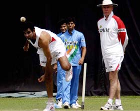 Indian pace bowler Zaheer Khan bowls while coach Greg Chappell looks on 