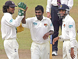 Sri Lankan spinner Muttiah Muralitharan, wicketkeeper Kumar Sangakkara and Tillakaratne Dilshan celebrate the dismissal of West Indies batsman Ryan Ramdass