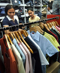 Two women at a store in Manila look at a row of imported dresses on Tuesday. Imports to the Philippines rose 2.7 per cent from a year earlier to $ 3.67 billion
