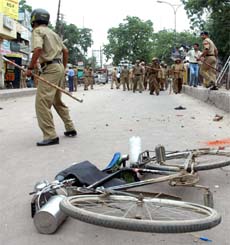 Policemen move towards the protesters