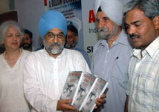 Dr Montek Singh Ahluwalia, Deputy Chairman, Planning Commission, releases the book A Billion is Enough, authored by Jalandhar Deputy Commissioner Ashok Gupta in Jalandhar on Tuesday. 