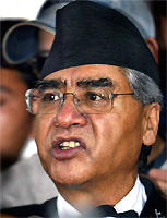 Sacked Nepali Prime Minister Sher Bahadur Deuba talks with reporters at the office of the Royal Commission for Corruption Control in Kathmandu on Tuesday