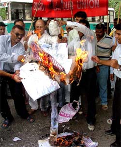 Bhartiya Labour Union activists burn the effigy of Haryana CM Bhupinder Singh Hooda to protest violence in Gurgaon at Jantar Mantar in the Capital