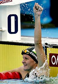 Zimbabwes Kirsty Coventry celebrates her victory in the womens 100m backstroke at the World Aquatic Championships in Montreal on Tuesday
