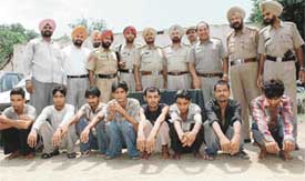 Cops with a gang of thieves allegedly involved in several crimes, including the murder of a child