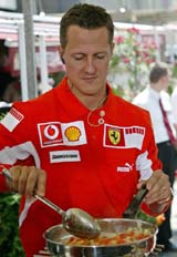 Formula One driver Michael Schumacher of Germany cooks during a television show in Budapest