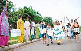 Members of the UT Government School Contractual Teachers Association make a human chain near the Matka Chowk, Chandigarh, on Saturday