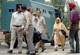 An armoured vehicle provides cover to the rescued persons at Badshah Chowk in the heart of Srinagar on Saturday.