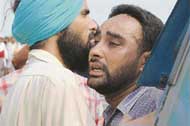 Gurdeep Singh, a brother of Paramjit Singh, one of the victims, being consoled by a friend at the accident site
