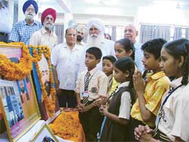 Children and trustees of the Udham Singh Memorial Trust pay tributes to Udham Singh on his martyrdom day in Ludhiana on Sunday