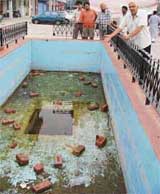 A resident shows a fountain that has been lying non-functional for several months