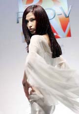 A Chinese model shows off the latest hairstyle during a launch of a new beauty and hair product in Beijing on Monday.