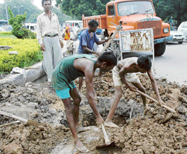 workers clear slush clogging drains at the roundabout of Sectors 27/19/26/7