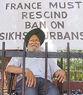 Sangat Singh, a resident of Janak Puri, sits on a dharna to protest against the French government decision to ban wearing of turbans in the country at Jantar Mantar in the Capital on Monday. 