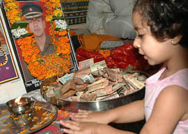 A child pays tributes to Major Kapil Vinayak during the past rites’ ceremony performed at Geeta Mandir in Jalandhar on Monday.