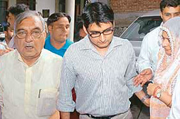 Haryana Chief Minister, Mr Bhupinder Singh Hooda, his son, Deepinder Hooda and wife Asha Hooda, coming out of a Panchkula court on Tuesday