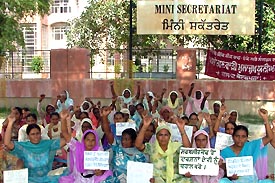 Anganwadi workers protest in favour of their demands outside the mini-secretariat in Bathinda on Monday