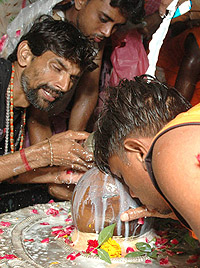 Kanwarias offering milk and Ganga jal which they brought from Hardwar on the occasion of Chaturdeshi of Sawan in the Capital on Tuesday