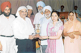 Upasna Kaushal, university topper, being honoured by Venod Sharma, Excise and Taxation Minister, Haryana along with committee members, principal and staff of GNN College, Doraha.