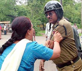 A member of the Mahila Utpeedan Virodhi Morcha assaults a policeman in Bhopal on Wednesday during a protest against Madhya Pradesh Chief Minister Babulal Gaur
