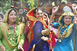 Celebrating the rains: Girls dressed in all their finery perform the giddha at the Teej festival in Amritsar on Wednesday.