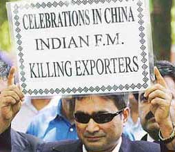An exporter holds a placard during a protest in New Delhi on Thursday.