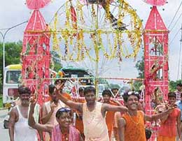 Kanwarias celebrate their annual journey, carrying kanwars (Ganga Jal), on their way to the Pracheen Shiv Mandir at Saketri.