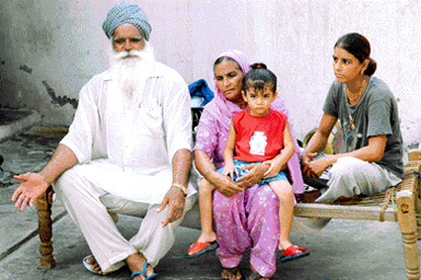 Surinder Singh, grandson of Ghadari Baba Harnam Singh, with his family members at Kala Sanghian village, Kapurthala