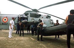 Indian naval commandos load equipment in the helicopter as they prepare to undertake a rescue mission from the Mumbai naval base on Thursday. 