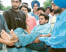 Deepinder, a PUSU activist, and Jaspal of SOPU, being removed from the dharna site in front of the office of the Vice-Chancellor, Panjab University, on Friday. 