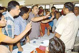 Members of the Universal Coop House Building Society exchange heated words with officials of the society on the issue of draw of lots in Chandigarh on Friday.