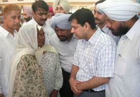 DC Anurag Verma listens to an elderly woman at Suvidha programme at the Community Centre, Machhiwara