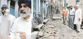 A resident shows muddy water being supplied at Mohalla Rajan in Kharadian Bazar and the dug-up street with manholes