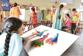 A physically challenged student at a painting competition held at Khalsa College for Women, Civil Lines