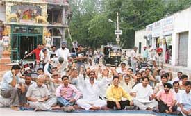 Shopkeepers and residents of Block I, BRS Nagar, stage a demonstration against the forcible eviction of a shopkeeper