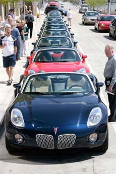 A line of 2006 Pontiac Solstice vehicles line the street outside the Wintergarden at the GM Renaissance Centre before a ceremony to present the first Solstice in Detroit