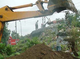 PUDA staff demolish a waterfall built by a multinational company on the Amritsar-Jalandhar road on Saturday.