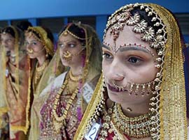 Indian women wait for the results of a bridal make-up competition in Ahmedabad on Sunday. More than 1,800 make-up artists participated in the four-day event. 