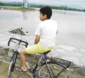 This lad is riding his own bike but the problem is that bicycles are not allowed in the lake area