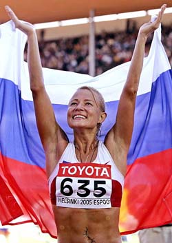 Olimpiada Ivanova of Russia waves her national flag after winning the womens 20 km walk at the World Athletics Championships in Helsinki